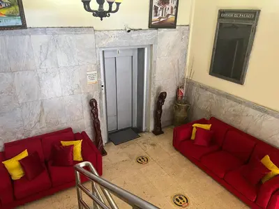 two red couches with yellow pillows in a room at Aparta Hotel Roma in Santo Domingo