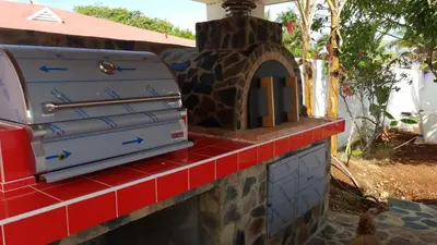 a pizza oven sitting on top of a brick counter at Villa de Colores 3 Rooms 5 king Beds in Sosúa
