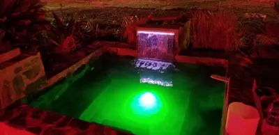 a green light in a swimming pool in a room at Villa de Colores 3 Rooms 5 king Beds in Sosúa
