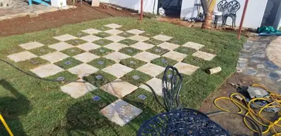 a stone chess board on the grass in a yard at Villa de Colores 3 Rooms 5 king Beds in Sosúa