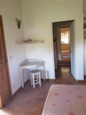 a room with a table and a table and a stool at Casa Flamingo in Las Terrenas