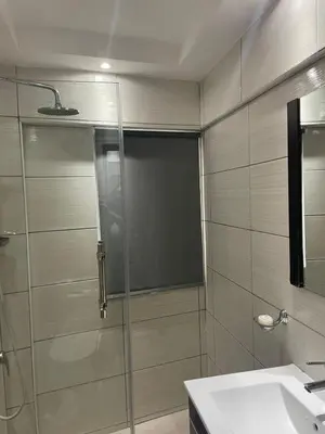 a bathroom with a glass shower and a sink at City Caribbean Hotel Boutique in Santo Domingo