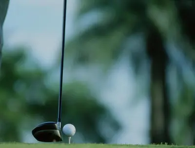a golf ball sitting next to a golf club at Sybaris Suites & Residences in Juan Dolio