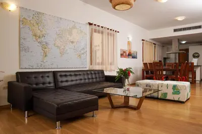 a living room with a couch and a map on the wall at Sybaris Suites & Residences in Juan Dolio