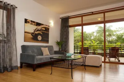 a living room with a couch and a glass table at Sybaris Suites & Residences in Juan Dolio