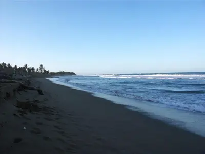 an empty beach with the ocean in the background at Beachfront apartment near Cabarete in Cabarete