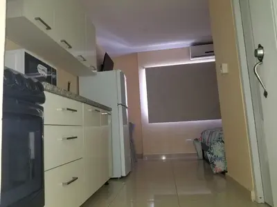 a kitchen with a white refrigerator in a room at Apartamentos Roman in Santo Domingo