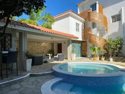 a swimming pool in front of a house at Bahia Residence Cabarete in Cabarete