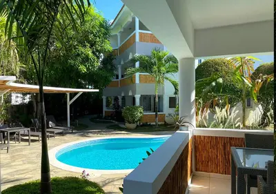a swimming pool in front of a building at Bahia Residence Cabarete in Cabarete