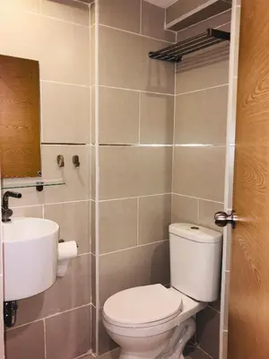 a bathroom with a toilet and a sink at Estancia Riviera Colonial I in Santo Domingo