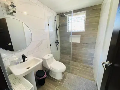 a bathroom with a toilet and a sink and a shower at Playa Dorada Mountainview Villa in San Felipe de Puerto Plata