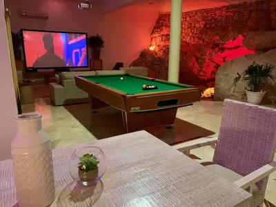 a living room with a pool table and a tv at Casa Coral Sosua in Sosúa