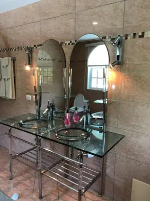 a bathroom with two sinks and a large mirror at Casa Coral Sosua in Sosúa