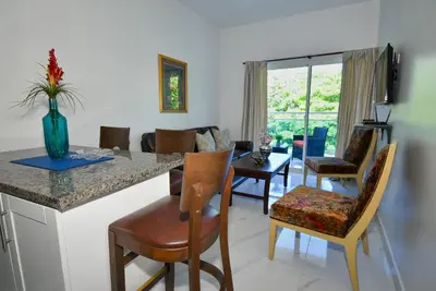 a kitchen and living room with a table and chairs at Rosil Place in San Felipe de Puerto Plata