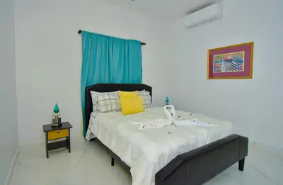 a bedroom with a bed with two dolls on it at Rosil Place in San Felipe de Puerto Plata