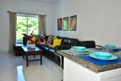 a living room with a couch and a table at Rosil Place in San Felipe de Puerto Plata