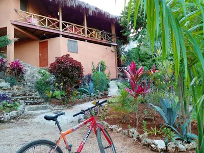 a red bike parked in front of a house at Welcoming House in Las Galeras with Stunning Sea View in Las Galeras