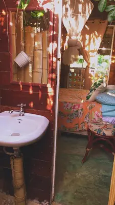 a bathroom with a sink and a bed in a room at GuaiGüí Bayahibe in Bayahibe