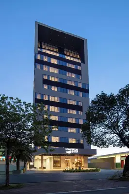 a tall office building with a lot of windows at Homewood Suites By Hilton Santo Domingo in Santo Domingo
