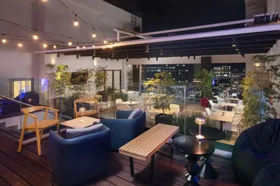 a restaurant with blue chairs and tables and a patio at Homewood Suites By Hilton Santo Domingo in Santo Domingo