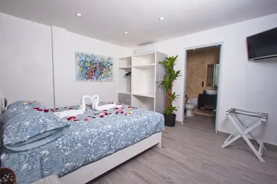 a bedroom with a bed with flowers on it at La Aldea in Santo Domingo