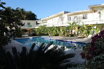 a swimming pool in front of a building at Hotel Magic Tropical in Boca Chica