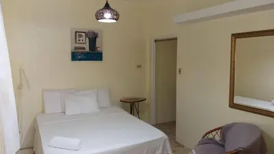 a bedroom with a white bed and a mirror at Hotel Magic Tropical in Boca Chica