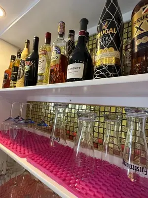 a refrigerator filled with lots of bottles of alcohol at Apartmenthotel Michaela in Sosúa