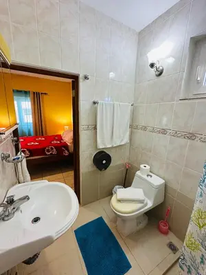 a bathroom with a white sink and a toilet at Apartmenthotel Michaela in Sosúa