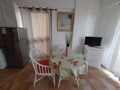 a kitchen with a table with a vase on it at Residence Meridiana in Juan Dolio
