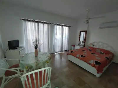 a bedroom with a table and a bed and a table and chairs at Residence Meridiana in Juan Dolio
