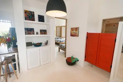 a room with a red cabinet and a living room at Casa Blava with AC in Las Galeras