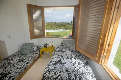 a room with a couch and a large window at Villa Cuatro Peces in Las Galeras