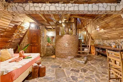 a bedroom with a bed in a wooden room at CHALET TROPICAL Hotel & Pool Bar Restaurant in Las Galeras