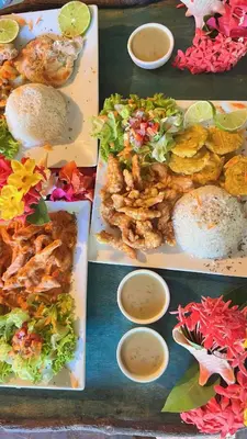 a group of plates of food on a table at CHALET TROPICAL Hotel & Pool Bar Restaurant in Las Galeras