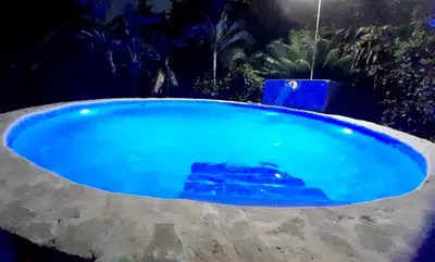 a large blue swimming pool in a yard at Labellaventura in Las Galeras