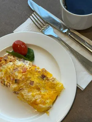a white plate with a piece of food on it at Micro Hotel Condo Suites in Santo Domingo