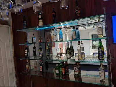 a bar with several shelves filled with bottles of alcohol at Micro Hotel Condo Suites in Santo Domingo
