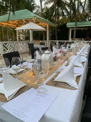 a long table with wine glasses and napkins at Hotel Villa Serena in Las Galeras