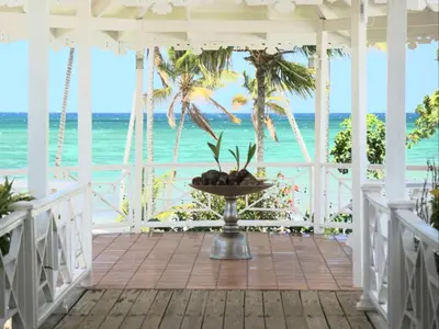 a view of the beach from the porch of a beach house at Hotel TODOBLANCO, Las Galeras, SAMANA in Las Galeras