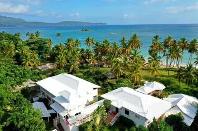 an aerial view of a resort with palm trees and the ocean at Hotel TODOBLANCO, Las Galeras, SAMANA in Las Galeras