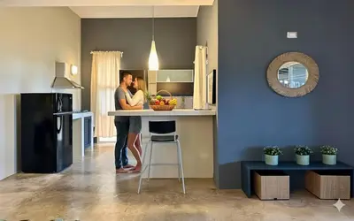 two people standing at a counter in a kitchen at Las Galeras Village Ecolodge in Las Galeras