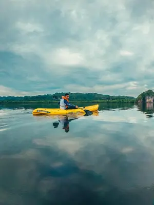 a man in a yellow kayak on a lake at Paraiso Caño Hondo in Los Guineos Perdidos