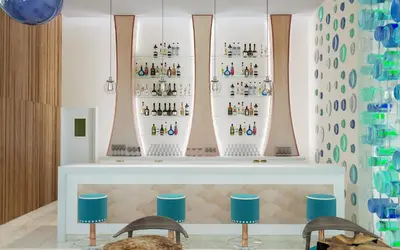a room with two chairs and a shelf with bottles at Iberostar Selection Coral Bavaro - All Inclusive in Punta Cana