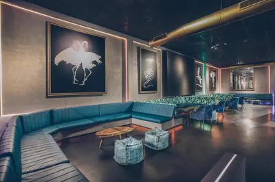 a lobby with a green couch and tables and chairs at Iberostar Selection Coral Bavaro - All Inclusive in Punta Cana