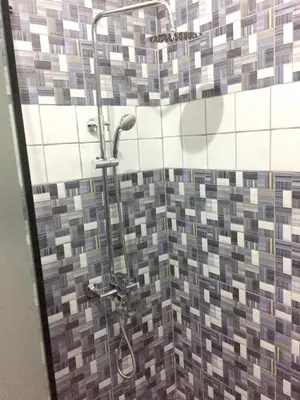 a shower with a mosaic tile wall in a bathroom at Elegant Villa with Sea View in Sosúa | Private Pool in Sosúa