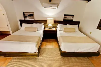 two beds sitting next to each other in a room at El Morro Eco Adventure Hotel in San Fernando de Monte Cristi