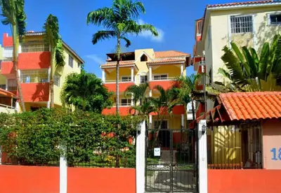 a fence in front of some apartment buildings at Parco del Caribe in Boca Chica
