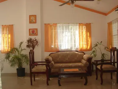 a living room with a couch and two chairs at Dre Broeders Apartments Juan Dolio in Juan Dolio