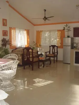 a living room with chairs and a table and a couch at Dre Broeders Apartments Juan Dolio in Juan Dolio